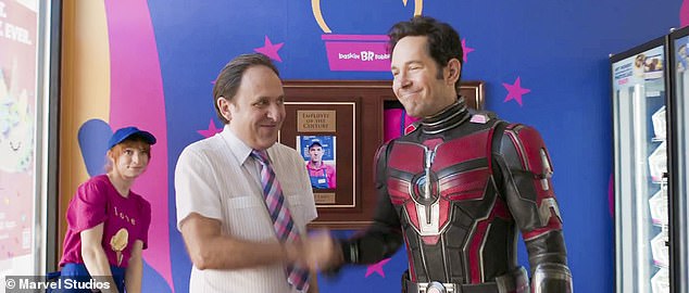 Ant-Man shaking hands with another character at a Baskin-Robbins store in Ant-Man and the Wasp: Quantumania movie.