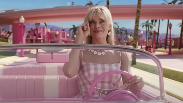 Barbie driving her iconic pink Corvette in Barbie the Movie.