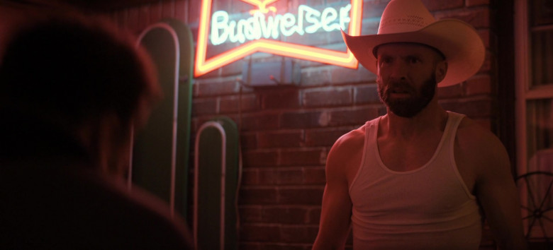 Budweiser beer neon sign displayed in the background of a scene in The Big Door Prize.