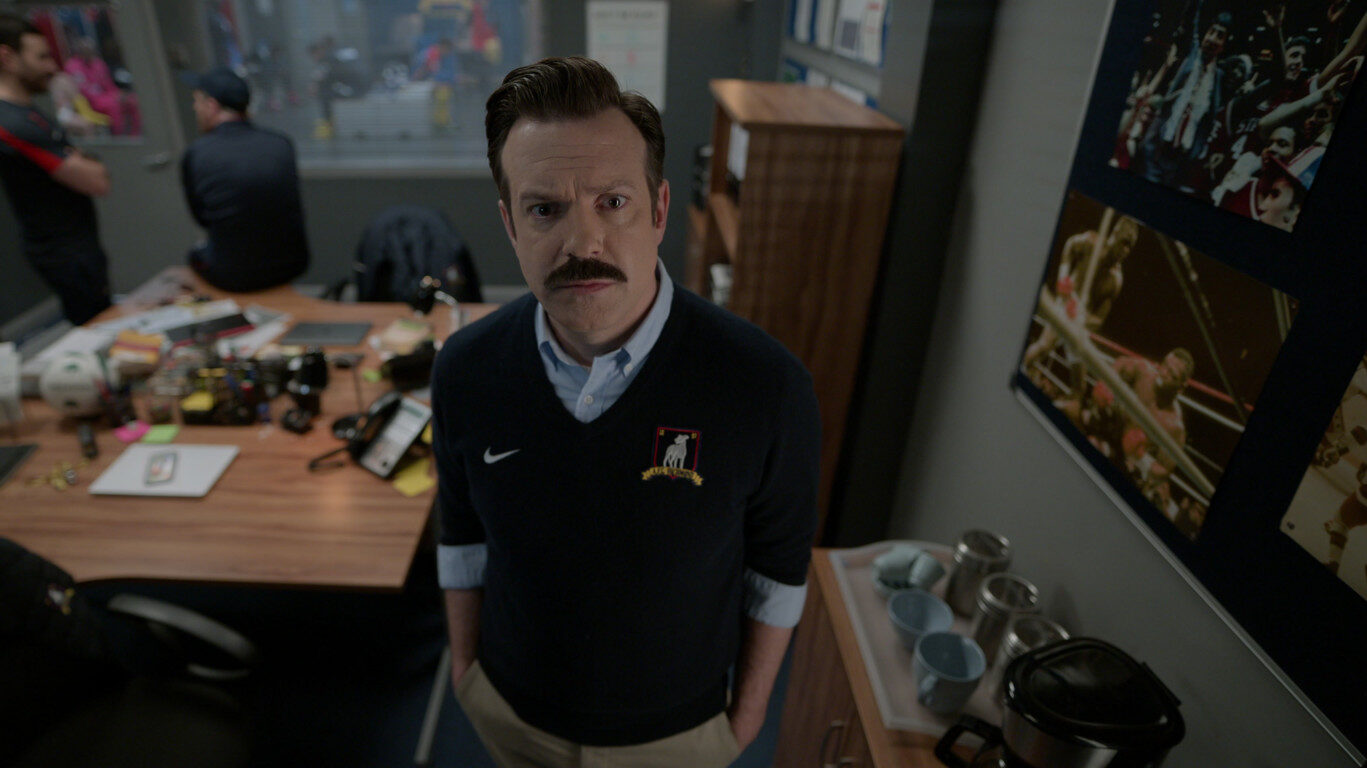 Ted Lasso wearing a Nike sweater.