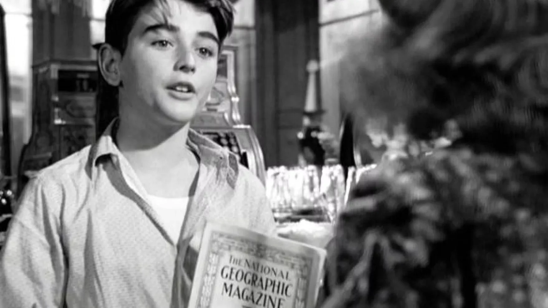 Character pointing at a National Geographic Magazine in It's a Wonderful Life