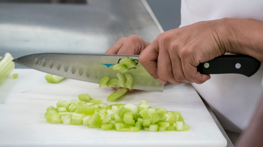 Tina chops celery with a Mac knife in The Bear